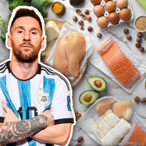 Lionel Messi Vistiendo La Camiseta De La Selección Argentina, Rodeado De Una Selección De Alimentos Saludables Que Reflejan La Disciplina Nutricional De Los Futbolistas De Élite Para Optimizar Su Rendimiento.